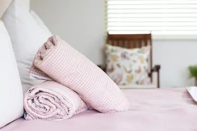 a pink sock on top of a bed at Studio 98 - 300m from cliff path in Hermanus