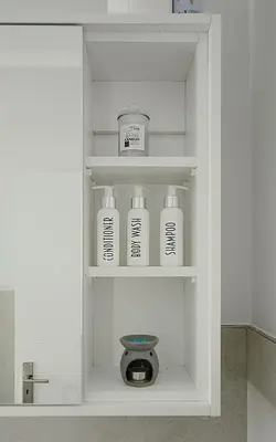 a shelf with four bottles in a bathroom at Leetch Views - Budget Room in Cape Town