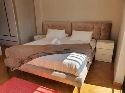 a bedroom with a large bed with white pillows at Classy 3 storey house in Gordonʼs Bay