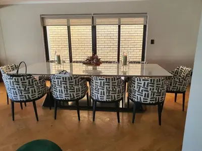 a dining room with a table and chairs at Classy 3 storey house in Gordonʼs Bay