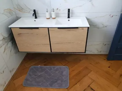 a bathroom with a sink and a dogmat on the floor at Classy 3 storey house in Gordonʼs Bay