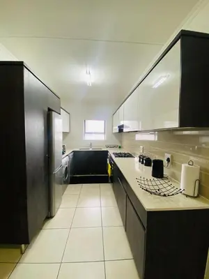 a kitchen with a counter and a stove top oven at Altin Pearl Luxury Apartment in Cape Town