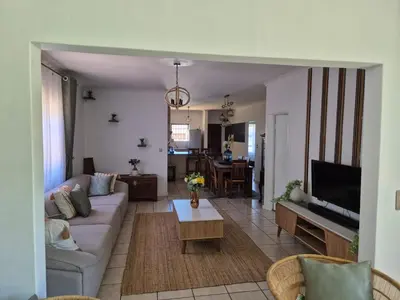 a living room with a couch and a tv at ESME's REST in Cape Town