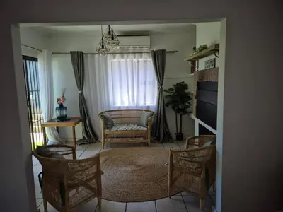 a living room with a couch and chairs and a table at ESME's REST in Cape Town