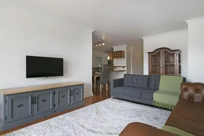 a living room with a couch and a flat screen tv at Gordonia 10 in Cape Town