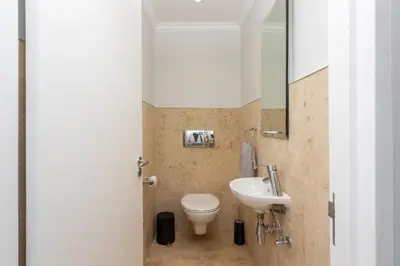 a bathroom with a toilet and a sink at Luxury Lodge 5B, Pearl Valley Golf Estate in Simondium