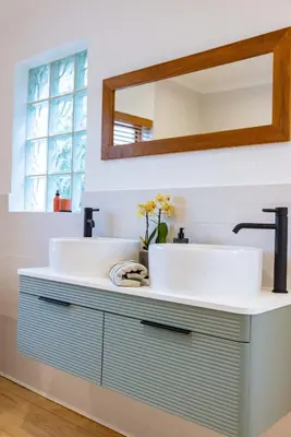 a bathroom with two sinks and a mirror at Onrus Island Milkwood Sanctuary in Hermanus