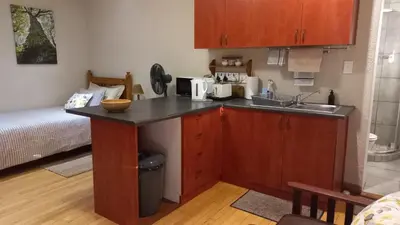 a kitchen with a sink and a counter top at 'The Cape Robin' studio apartment in Hoheizen