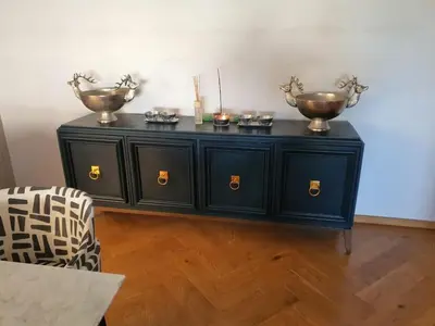 a black cabinet with two bowls on top of it at Classy 3 storey house in Gordonʼs Bay