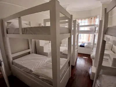 two bunk beds in a room with a window at Star legend backpackers - Parow in Parow