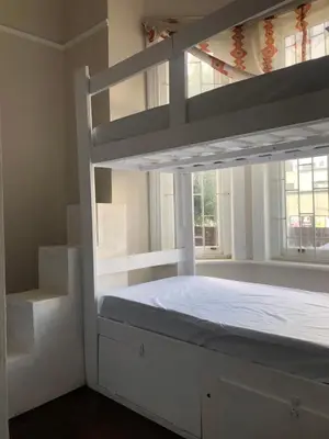 a white bunk bed in a room with a window at Star legend backpackers - Parow in Parow