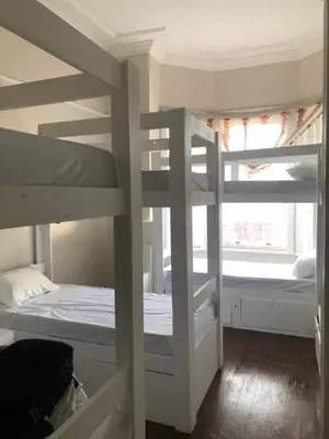 two bunk beds in a room with a window at Star legend backpackers - Parow in Parow