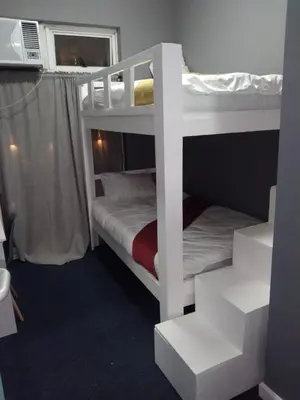 a bedroom with two bunk beds in a room at Star legend backpackers - Parow in Parow