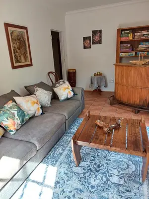 a living room with a couch and a coffee table at A Jungle House in Somerset West