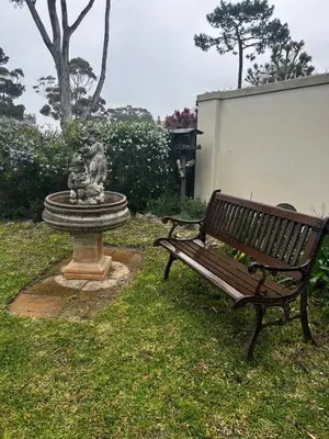 a park bench and a fountain with a statue at 16 on Fernkloof in Hermanus