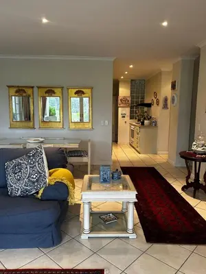 a living room with a blue couch and a table at 16 on Fernkloof in Hermanus