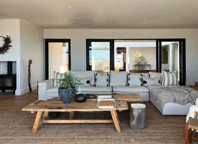 a living room with a couch and a coffee table at Hermanus Seafront Villa - Sophie's Rock in Hermanus