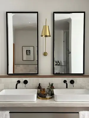 two sinks in a bathroom with two mirrors at Hermanus Seafront Villa - Sophie's Rock in Hermanus