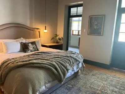 a bedroom with a bed with a blanket on it at Rooiheuwel in Botrivier