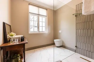 a bathroom with a toilet and a window at Rooiheuwel in Botrivier