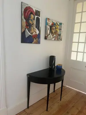 a black table in a room with paintings on the wall at The Alma House 1900 in Cape Town
