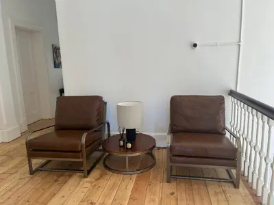 two chairs and a table and a lamp in a room at The Alma House 1900 in Cape Town