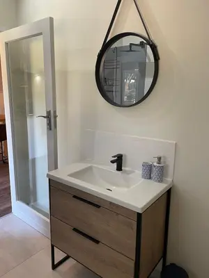 a bathroom with a sink and a mirror at The Studio - a lovely 1 bed loft apartment in Somerset West