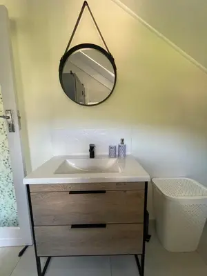 a bathroom with a sink and a mirror on the wall at The Studio - a lovely 1 bed loft apartment in Somerset West