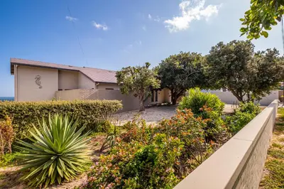 a house with a garden in front of it at Lawaaiwaters in Hermanus