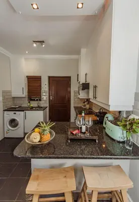 a kitchen with a counter with a bowl of fruit on it at Studio in Central Stellenbosch in Stellenbosch