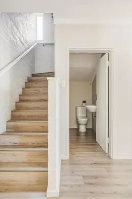 a staircase in a bathroom with a toilet and a sink at Villa Franlisa in Hermanus