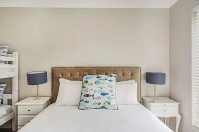 a bedroom with a bed with a pillow on it at Villa Franlisa in Hermanus