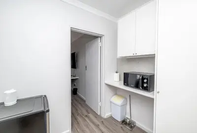 a room with a kitchen with a microwave on a counter at Infinite Studio str in Panorama