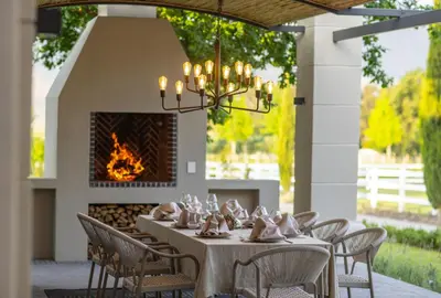 a dining room with a table and chairs and a fireplace at Oakvale Estate in Franschhoek