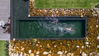 a person swimming in a pool of water at Oakvale Estate in Franschhoek