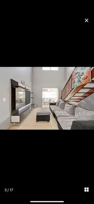 a living room with a couch and a fireplace at YA Eagle Wings Self Catering Shared Single Room Lodge A in Cape Town