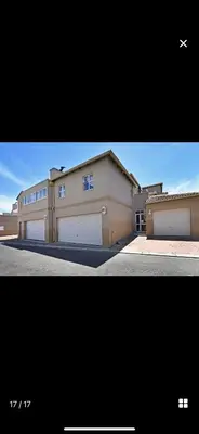 a large building with two garage doors and an airplane at YA Eagle Wings Self Catering Shared Single Room Lodge A in Cape Town