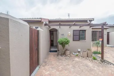 a house with a wooden gate and a driveway at Serenity at Cape Bay in Helderberg
