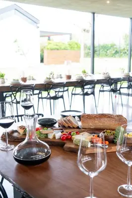 a table topped with sandwiches and wine glasses at EersteBosch Cottages in Stellenbosch