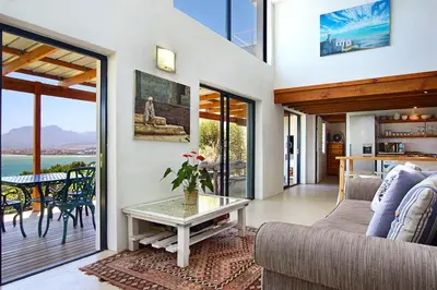 a living room with a couch and a table at 82 Suikerbossie in Gordonʼs Bay