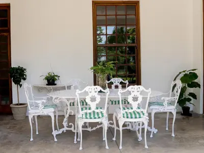 a white dining room table and four chairs at Vendome Wine Estate in Paarl