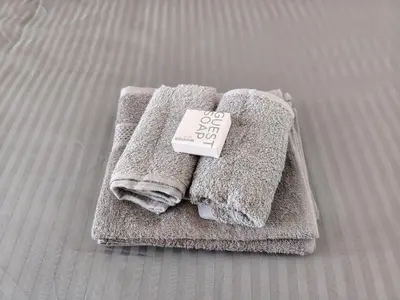 a pile of towels with a price tag on them at Kenwyn Micro Apartments in Cape Town