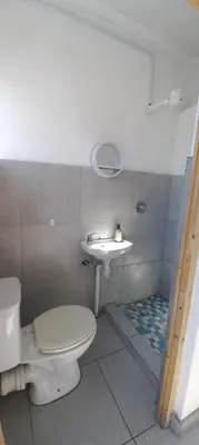 a bathroom with a toilet and a sink at Kenwyn Micro Apartments in Cape Town