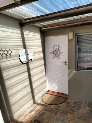 a garage door with a seahorse sign on it at Hermanus Beach Club 223 in Hermanus