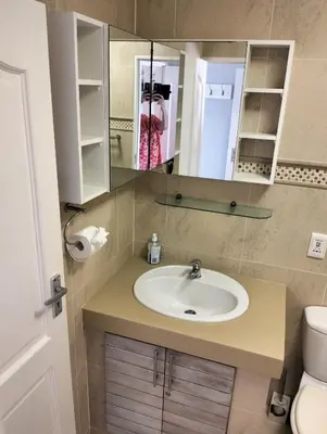a bathroom with a sink and a mirror at Hermanus Beach Club 223 in Hermanus