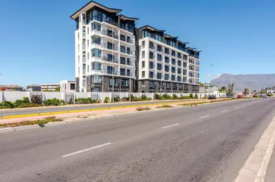 an empty road in front of a large building at Lifestyle Accommodation in Cape Town