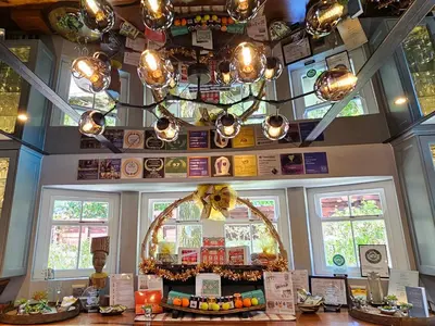 a restaurant with a chandelier and a table with food at Fleur du Soleil Luxury Guesthouse in Franschhoek