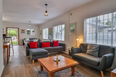 a living room with two couches and a table at Casa Mia in Hermanus