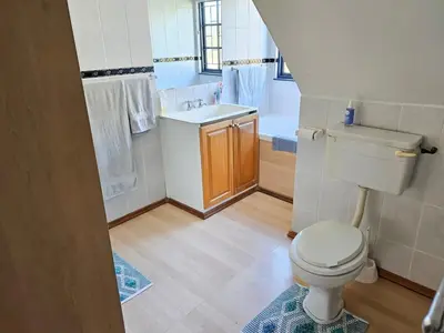 a small bathroom with a toilet and a sink at Indoor Pool Paradise in Stellies in Stellenbosch