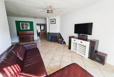 a living room with a couch and a flat screen tv at Indoor Pool Paradise in Stellies in Stellenbosch